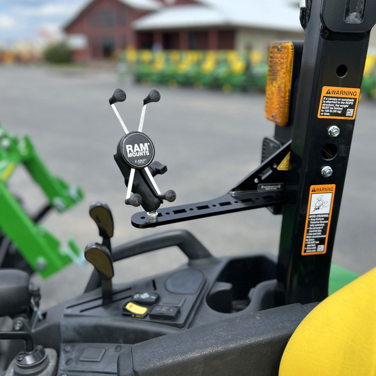 Mounting bracket for John Deere compact tractor without a cab. Pictured here with phone holder.