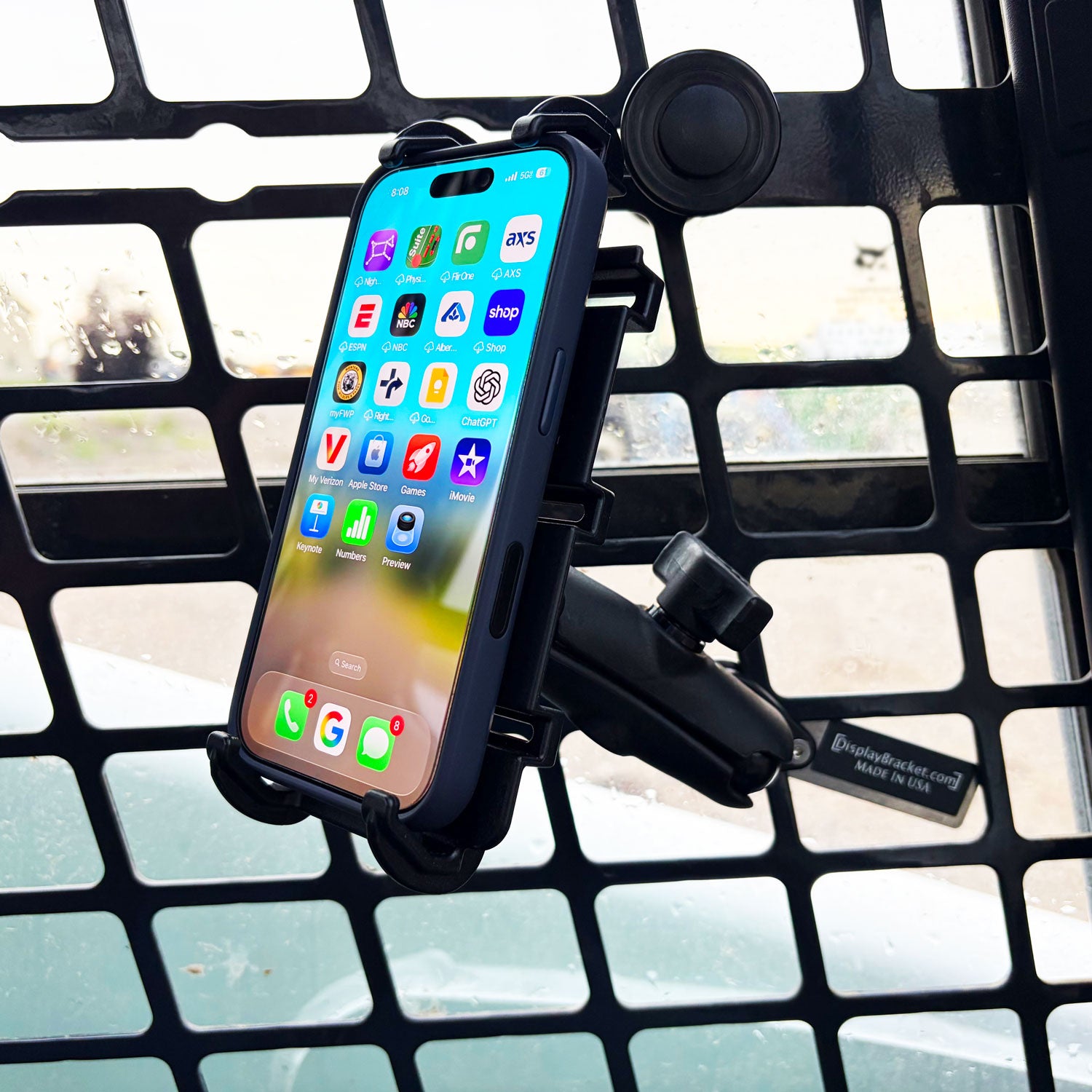 phone holder installed in the cab of a skid steer using the side grate.