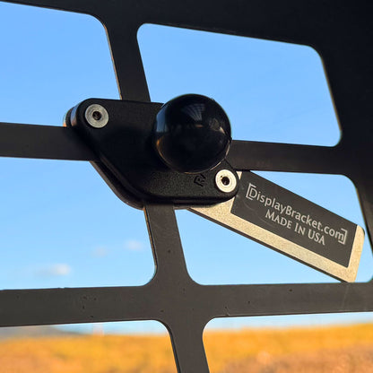 Ram mount ball attached to the side screen of a skid steer cab